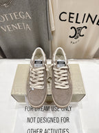 Golden Goose gray low-top sneakers with white lace-up closure