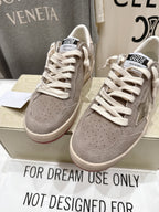 Golden Goose gray low-top sneakers, front view with perforated toe panels