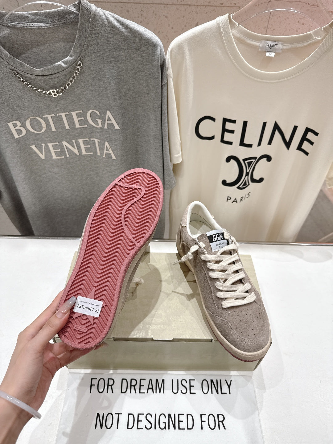 Golden Goose gray low-top sneaker with visible pink outsole and tread pattern