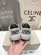 Back view of white luxury sneakers with black heel panels and 'SNEAKERS' text
