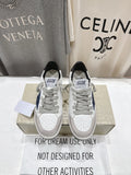 White luxury sneakers with gray laces, perforated toe, and GGD B label on tongue
