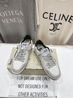 White luxury sneakers with gray laces and perforated toe; GGD B label visible