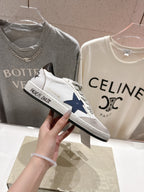 White luxury low-top sneakers with navy star patch and gray laces; side view