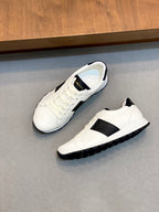 White sneakers on side; black stripe, lace-up front, and rubber tread sole