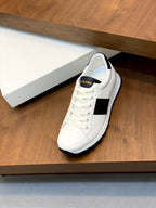 White lace-up sneakers with black side stripe and padded collar