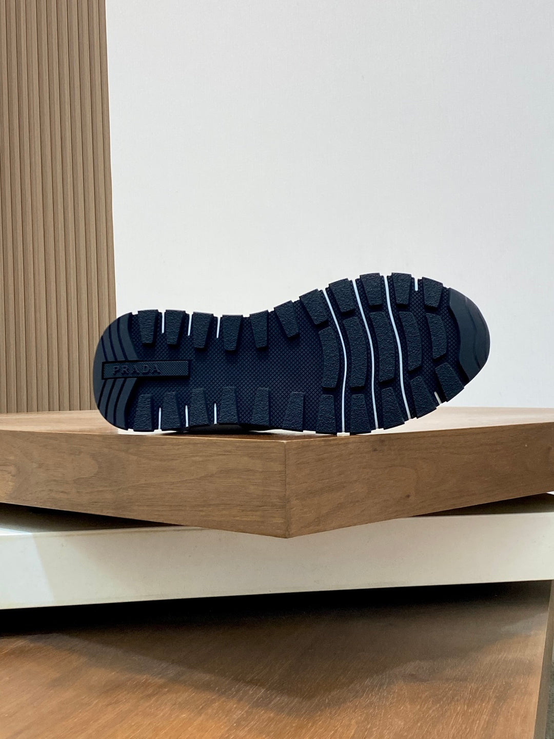 Navy rubber outsole with deep tread pattern on low-top sneakers