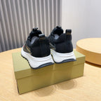 Rear view of dark sock sneakers with elastic collar and white cushioned sole