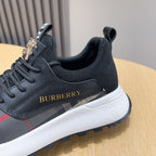 Close-up of dark lace-up sneaker with BURBERRY logo and check panel detail