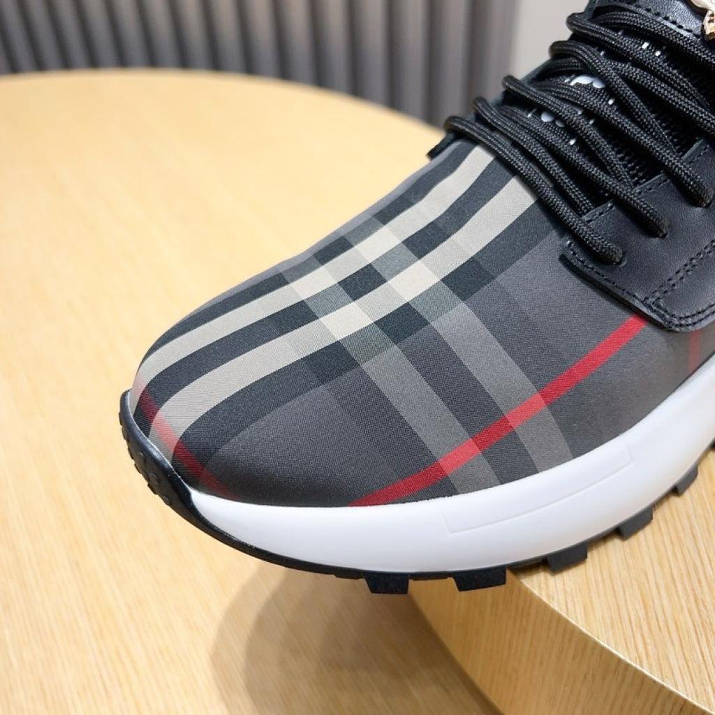 Toe and lace area of dark sneaker with check-pattern panel and white sole