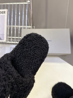 Balenciaga black fuzzy slide sandal close-up of toe strap and logo