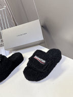 Balenciaga black fuzzy slide sandals, front view, logo patch on strap
