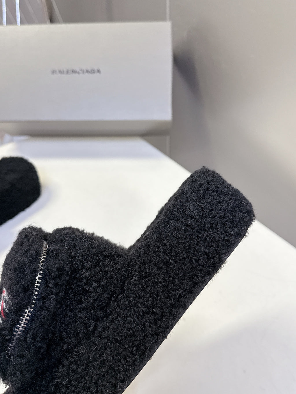 Balenciaga black fuzzy slide sandals close-up of toe strap and zipper