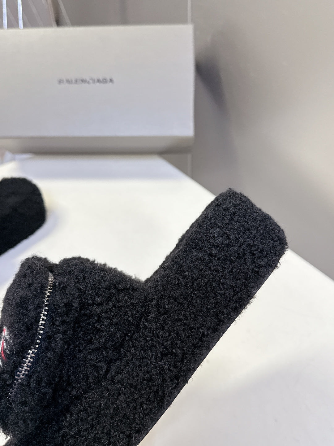 Balenciaga black fuzzy slide sandals close-up of toe strap and zipper