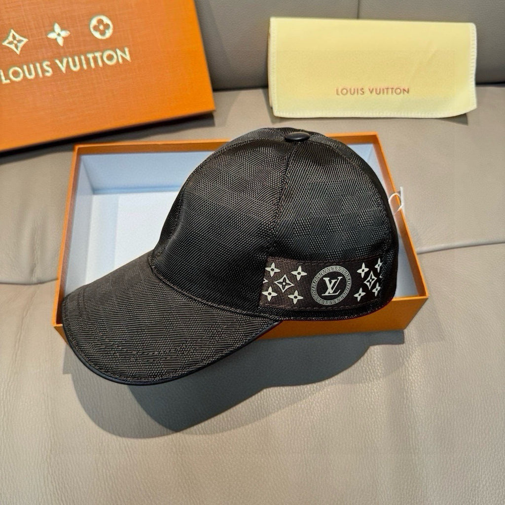 Black Louis Vuitton cap with front logo patch and curved brim, shown in box