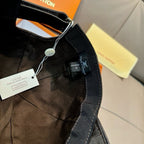 Black Louis Vuitton cap with fabric strap, metal clasp, and hanging tag