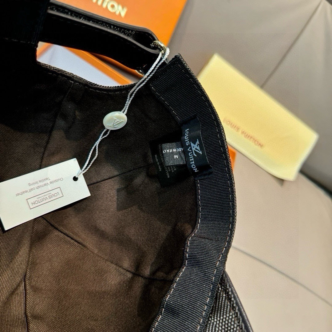 Black Louis Vuitton cap with fabric strap, metal clasp, and hanging tag