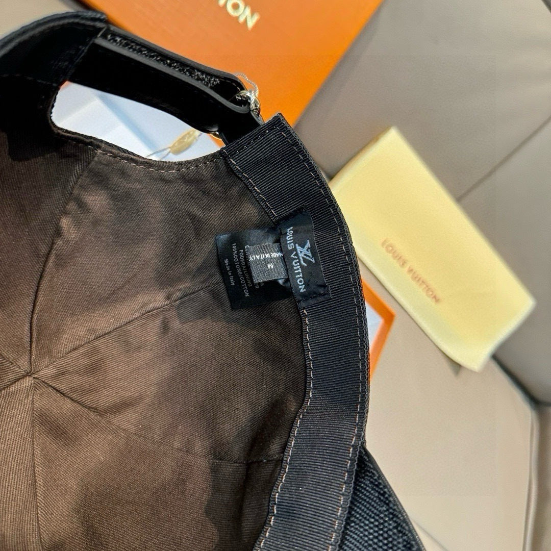 Black Louis Vuitton cap with visible woven fabric seam and neck strap tag