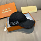 Black Louis Vuitton cap with monogram star emblem across front panel and curved brim