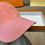 Close-up of pink cap brim with monogram stitching and curved seam