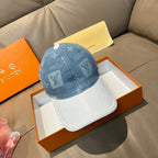 Louis Vuitton denim cap with blue monogram pattern and white contrast brim