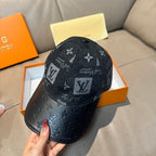 Louis Vuitton monogram baseball cap with dark fabric paneling and black leather brim