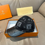 Louis Vuitton monogram baseball cap with dark patterned fabric and curved black brim