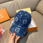 Denim blue monogram baseball cap with embroidered logos and curved brim