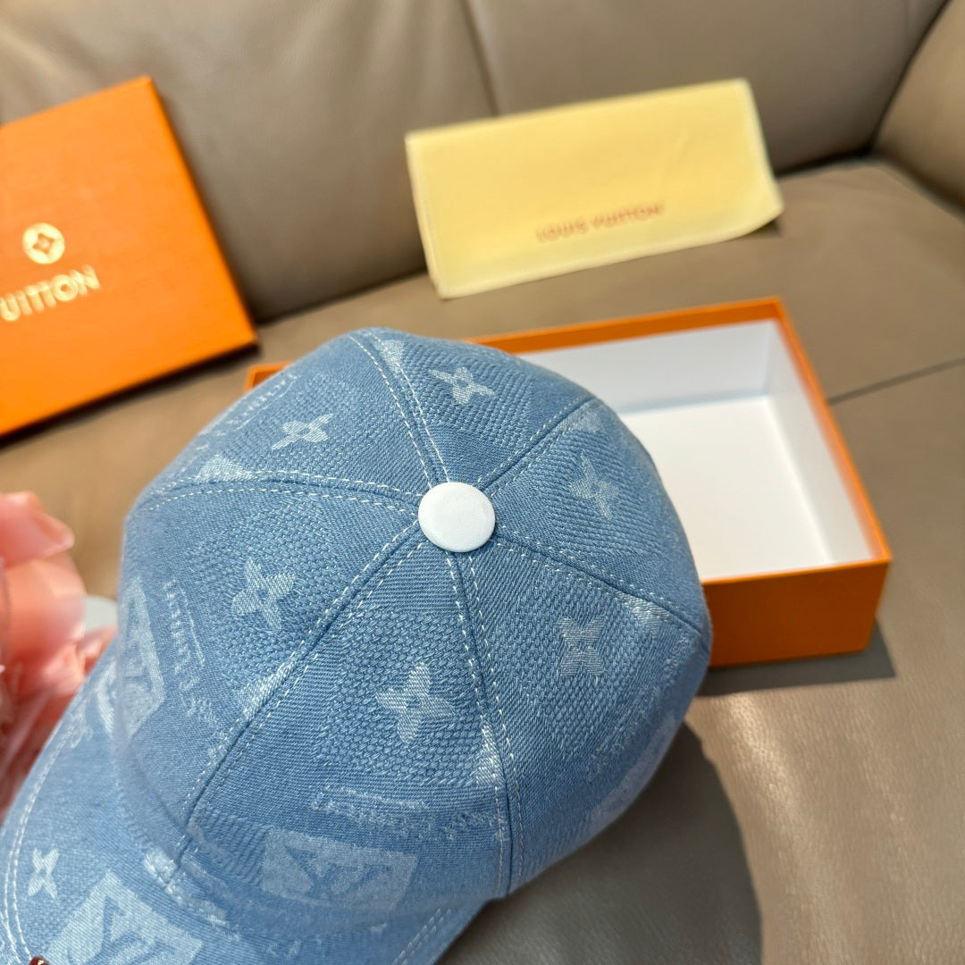 Louis Vuitton blue denim cap close-up of top panel with round button and monogram