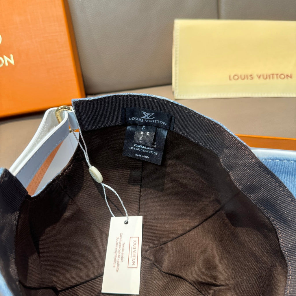 Louis Vuitton cap interior with black lining and adjustable strap, with hanging tag