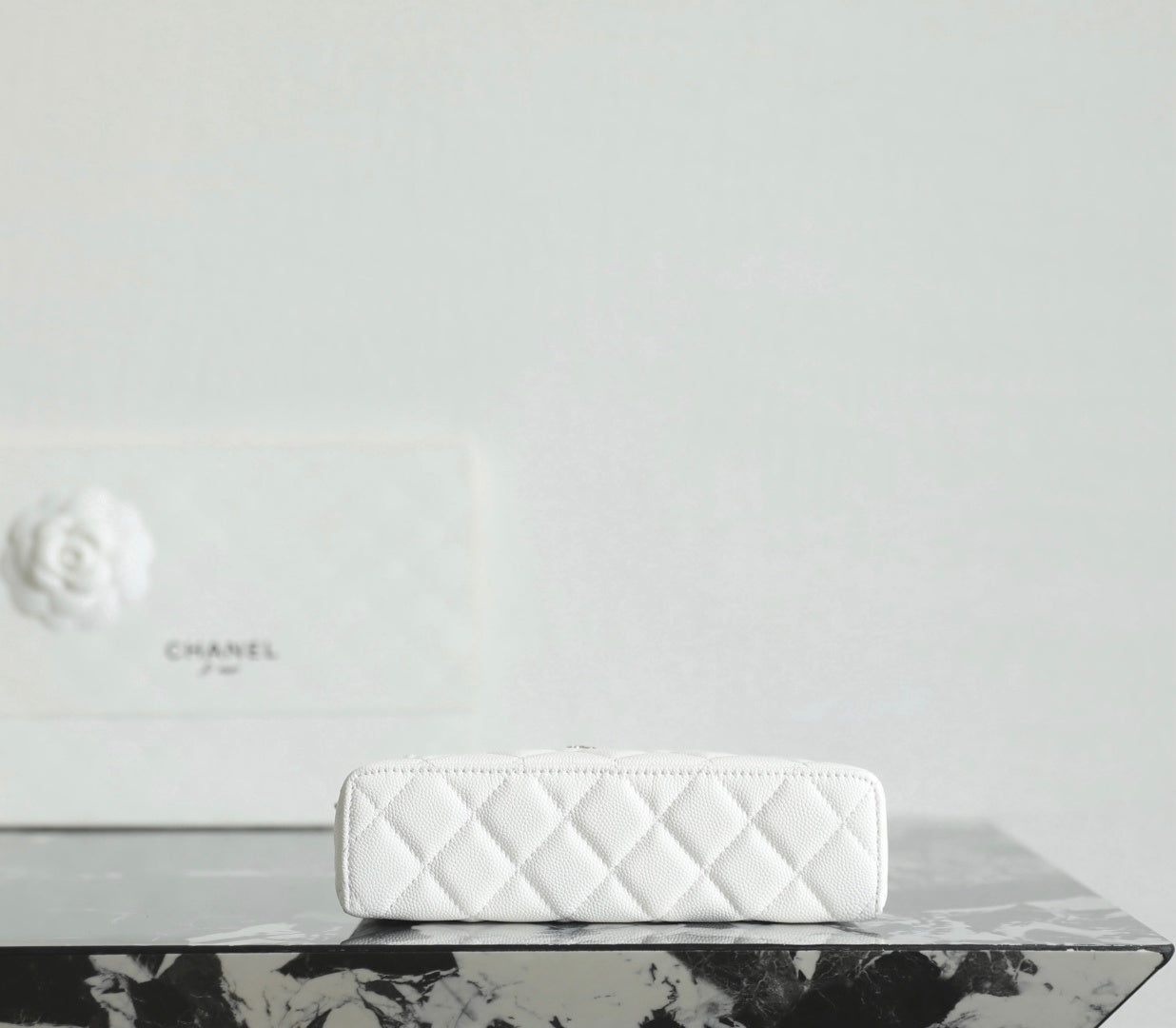 White Chanel quilted zip pouch with zipper top and small chain strap