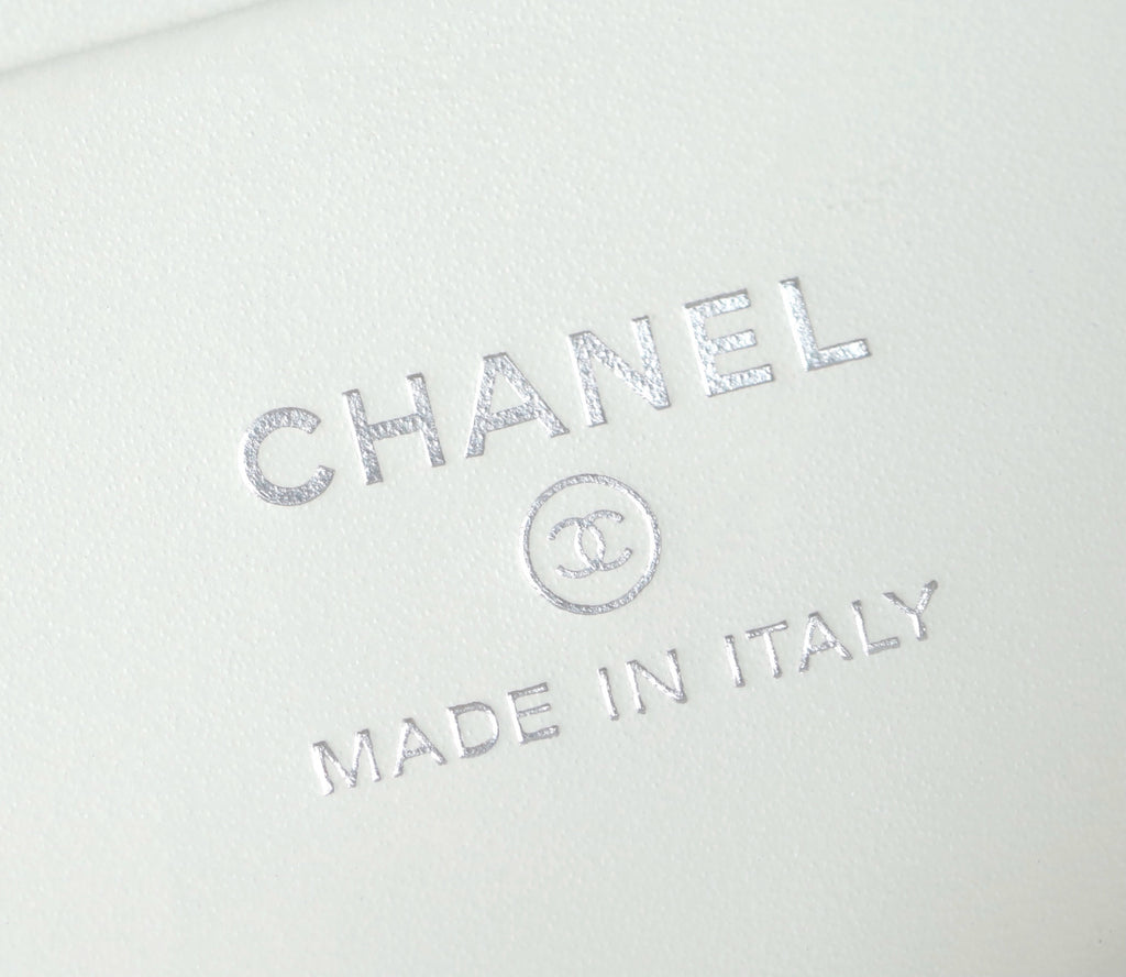 Embossed CHANEL and MADE IN ITALY mark on white leather