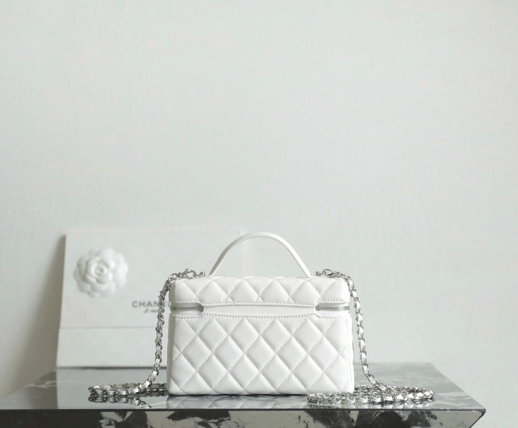 White quilted Chanel mini bag with top handle and chain crossbody strap