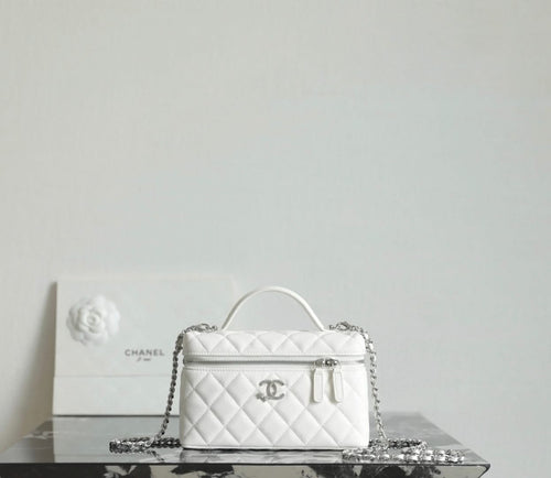 White Chanel quilted mini bag with top handle, chain strap, and front logo