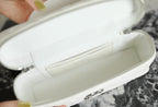 Open white Chanel bag showing interior lining and zipper closure