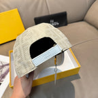 Fendi cap in light cream with side strap detail and curved brim.