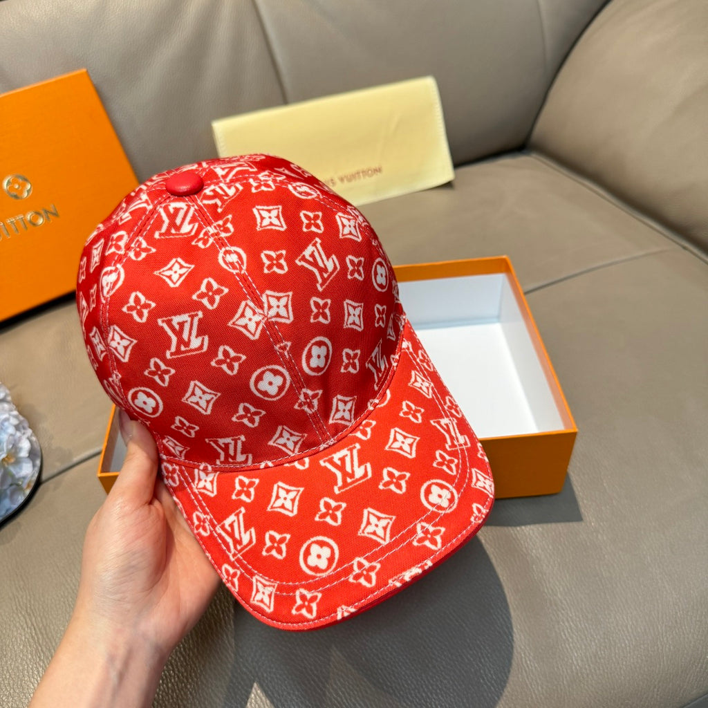 Louis Vuitton red monogram baseball cap with curved brim, shown from side in hand