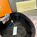 Black interior of baseball cap with Louis Vuitton label and hanging tags
