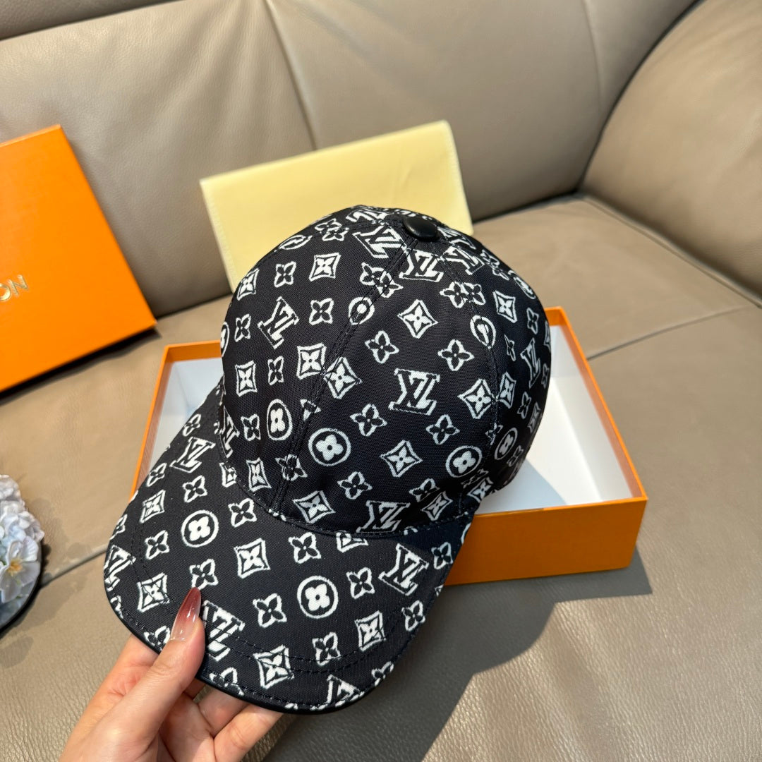 Louis Vuitton cap, black with white monogram pattern, curved brim and stitched crown.