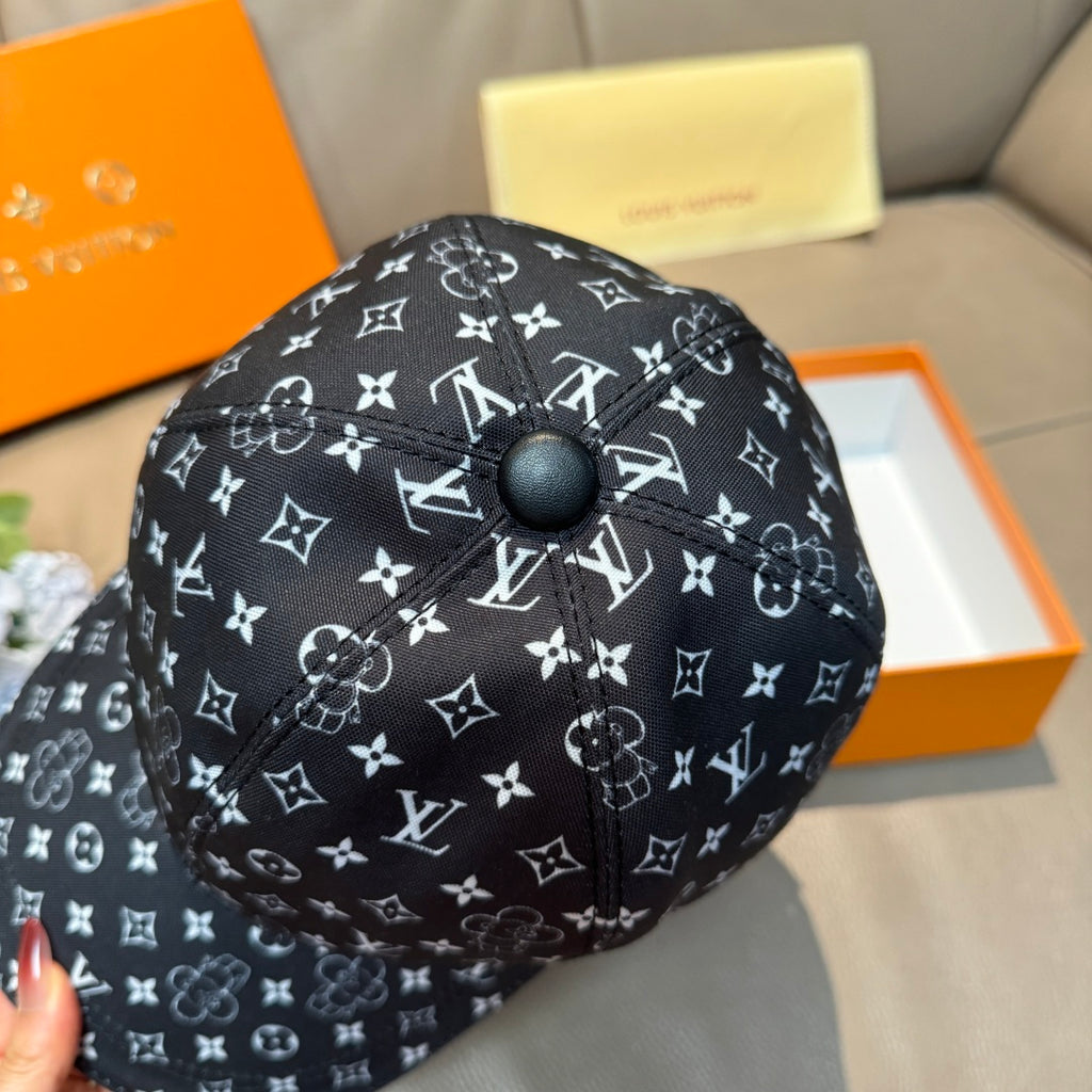 Black baseball cap with white monogram pattern, top button detail