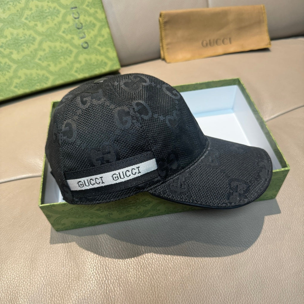Black Gucci monogram baseball cap with white GUCCI logo band and stitched brim