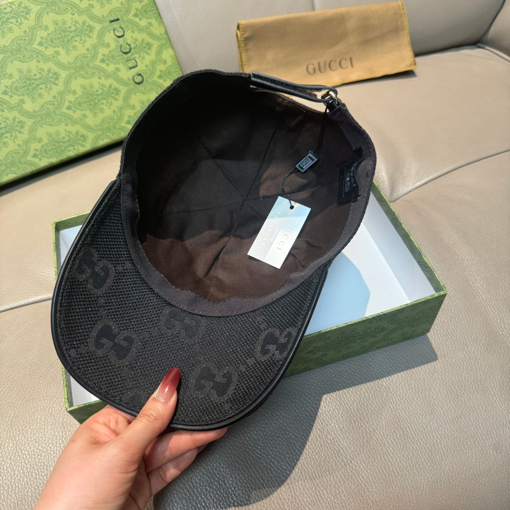 Black Gucci monogram cap interior with fabric lining and adjustable strap hardware