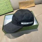 Black Gucci monogram baseball cap with white GUCCI logo band on brim