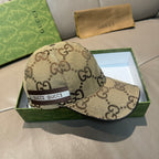 Beige Gucci monogram baseball cap with front logo web band and curved brim.