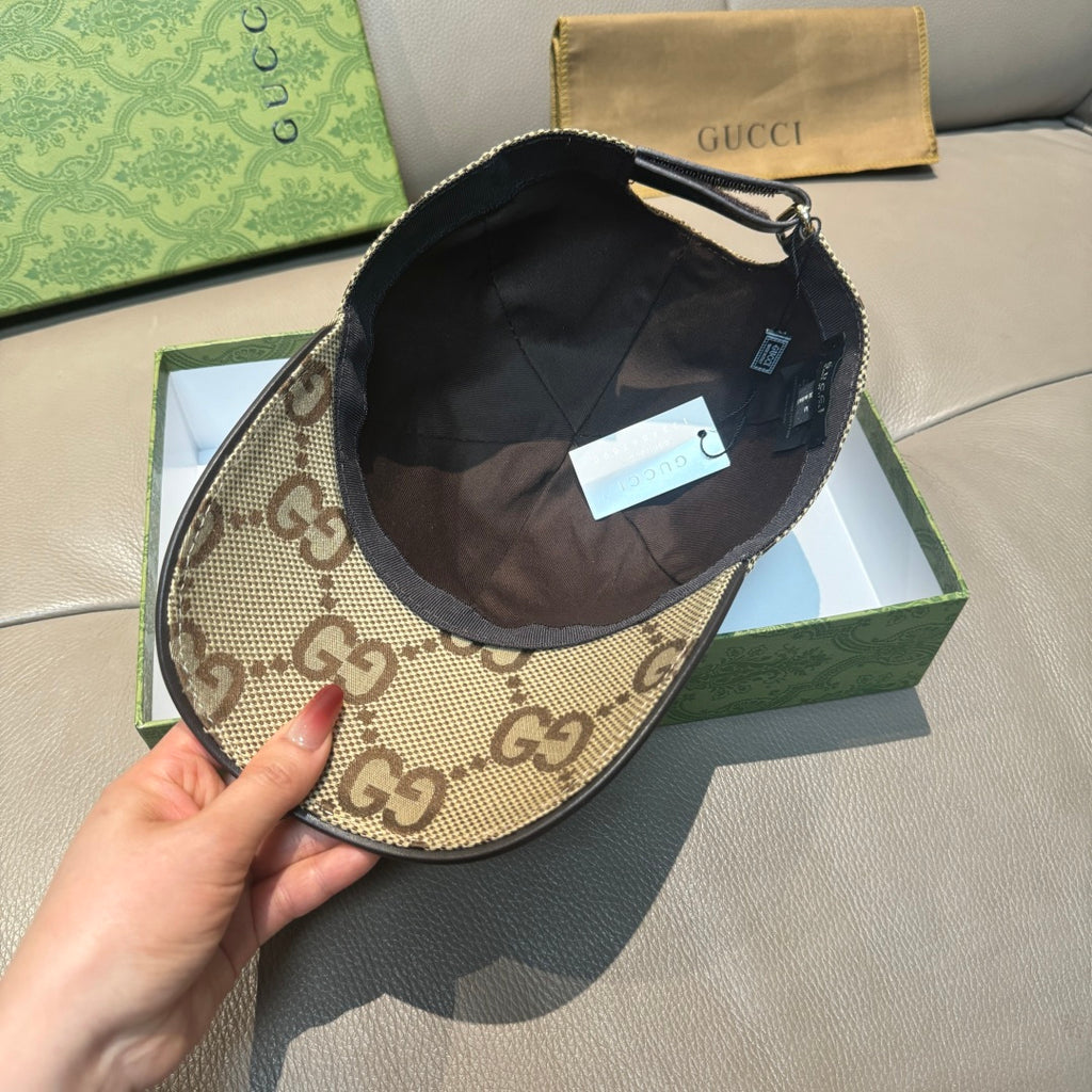 Gucci monogram baseball cap with dark interior lining, top button, and adjustable strap.