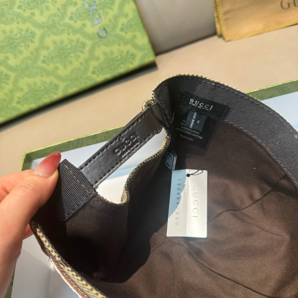 Gucci baseball cap inner view with adjustable strap, lining, and hanging tag.