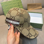 Gucci monogram baseball cap in beige with front GUCCI web band and brim trim.
