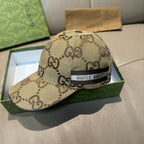 Gucci monogram baseball cap in beige with black web stripe and logo patch.