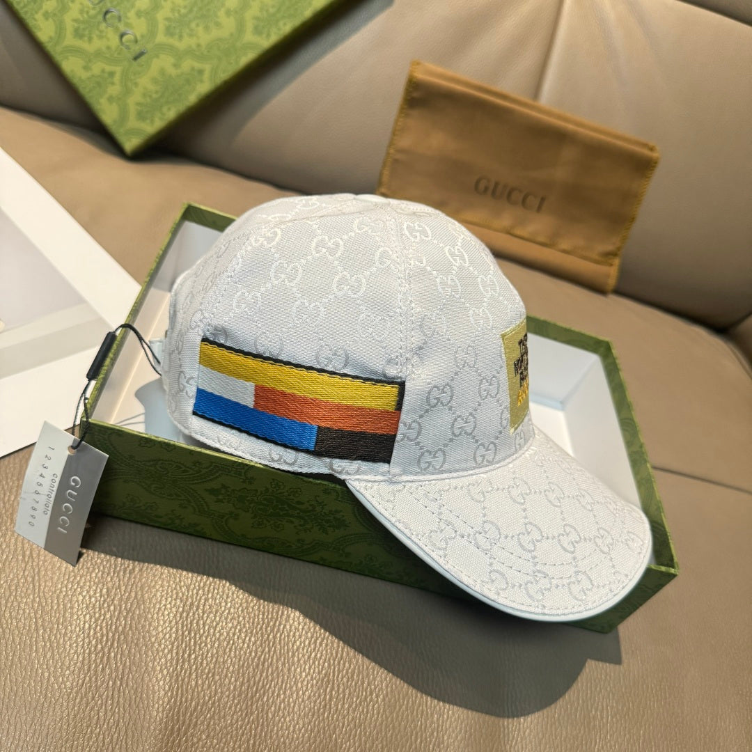 White Gucci baseball cap with GG monogram and blue-yellow-red front stripe