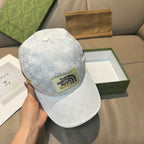 White Gucci baseball cap with GG monogram and round top button detail