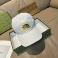 White Gucci baseball cap with GG monogram and The North Face logo patch